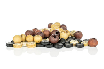 Lot of whole colorful wooden bead heap isolated on white wood