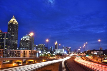 Midtown Atlanta interstate highway with light trails and a blue evening sky
