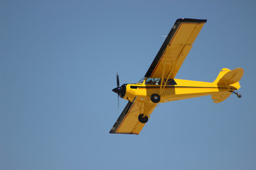 airplane with propeller flying in blue sky 