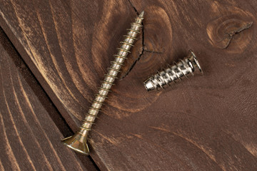 Group of two whole metallic glossy bolt flatlay on brown wood
