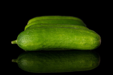Lot of whole mini green cucumber isolated on black glass