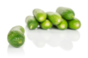 Lot of whole arranged mini green cucumber isolated on white background