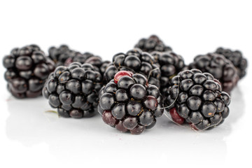 Dark lot of whole disordered fresh black blackberry isolated on white background