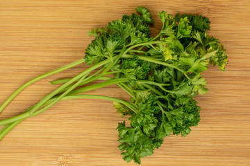 Lot of whole fresh green parsley flatlay on light wood