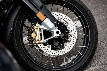 Fototapeta premium Front Motorcycle wheels in closeup.