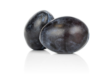 Group of two whole arranged fresh purple plum isolated on white background