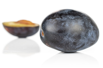 Group of one whole one half of fresh purple plum isolated on white background