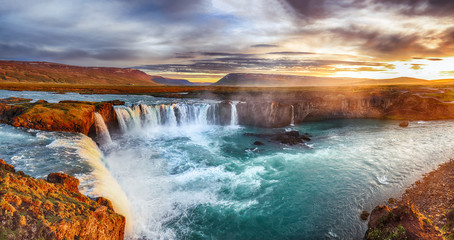 Fantastic sunrise scene of powerful Godafoss waterfall.