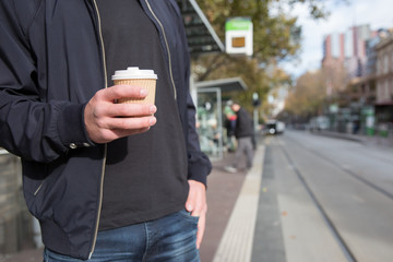 Man with Coffee Waiting for Tram