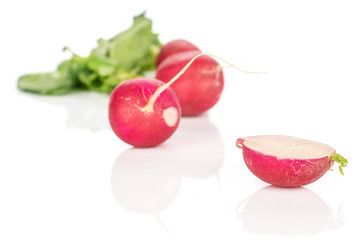 Group of three whole one half of fresh red radish isolated on white background