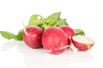 Group of three whole one half of fresh red radish isolated on white background