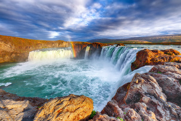 Breathtaking sunset landscape scene of powerful Godafoss waterfall