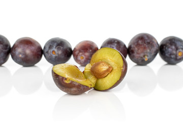 Group of lot of whole two halves of sweet purple plum isolated on white background