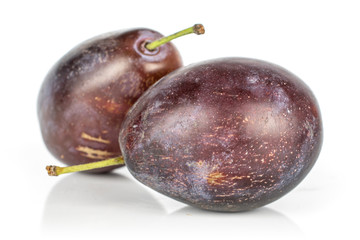 Group of two whole sweet purple plum isolated on white background