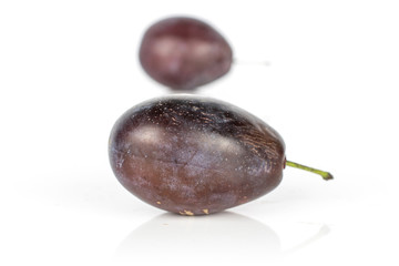 Group of two whole sweet purple plum isolated on white background