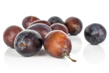 Lot of whole sweet purple plum isolated on white background