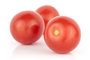 Group of three whole fresh red tomato isolated on white background