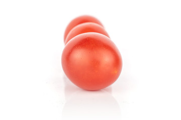Group of three whole fresh red tomato in row isolated on white background