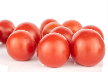 Lot of whole disordered fresh red tomato isolated on white background