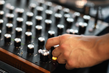 hand of a DJ who mixes music on a DJ controller