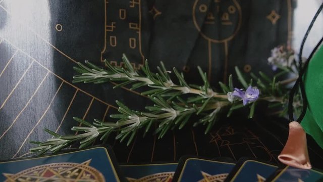Track in from tarot card to rosemary