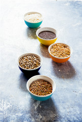 Variaty of raw cereals  on  bowls, top view flat lay,lentils, bulgur and quinoa, hemp seed,sunflower seeds ,brown rice, rice, healthy food concept , clean eating and detox concept.