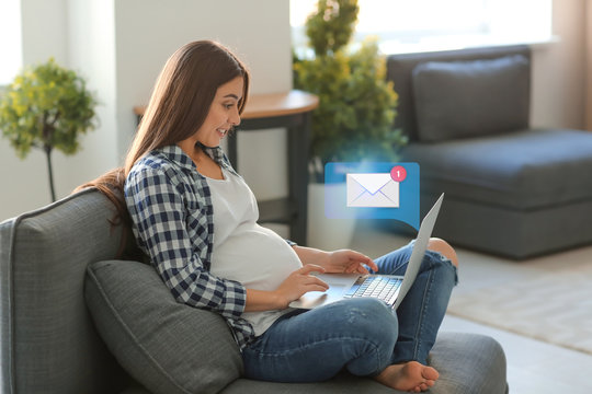 Young pregnant woman working at home