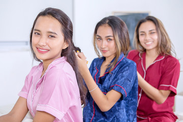 Group of pretty teenage girls tying hair to each other