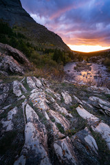 Landscape of a rock formation just beside Swiftcurrent alke with the sunrise on the background, Montana.
