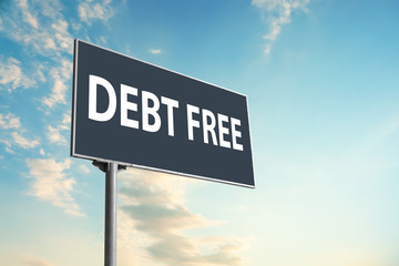 Billboard with text DEBT FREE against blue sky