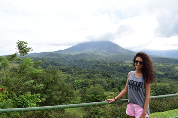 Girl with red dress. Volcano