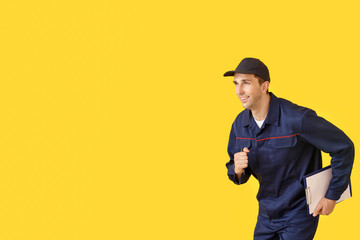 Running car mechanic on color background