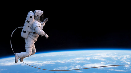 astronaut with safety tether performing a spacewalk in empty space  © dottedyeti