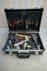  Opened toolbox of a messy handyman. Jumble of various old, rusty tools. Close-up. Unkempt, messy condition.  