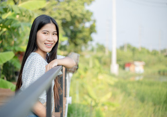 Naklejka premium An Asian woman with a smiling face and a side copying area.