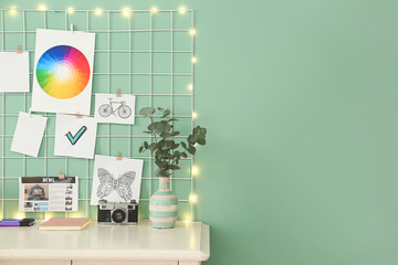 Comfortable workplace with mood board in room