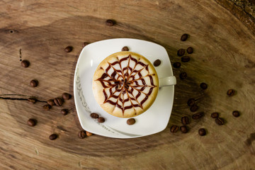 coffee cup latte art on wooden background