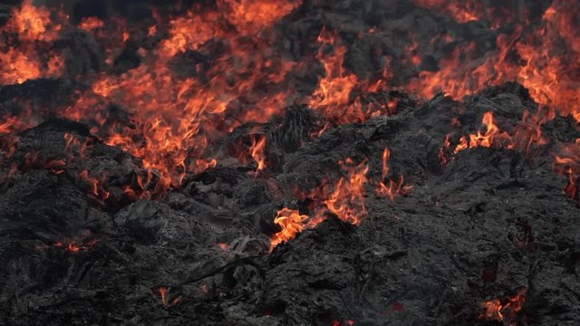 Texture of burning joss paper known as  ghost money in ceremony faith of Chinese people. Global warming and environmental pollution concept. fire on black background in slow motion.