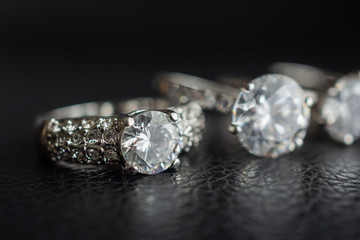 Close up diamond rings jewelry on black leather background