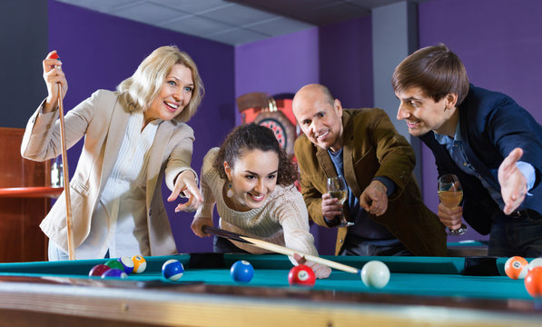 Cheerful positive smiling people playing billiard and darts
