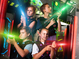 Happy teenagers with laser guns