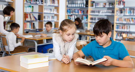 Girl and boy studying in school library