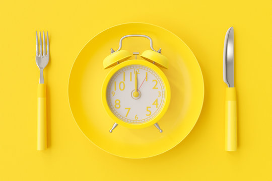 Yellow clock on the yellow plate