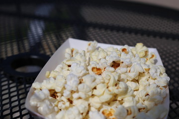 A tray of yummy white fluffy buttery and salty popcord