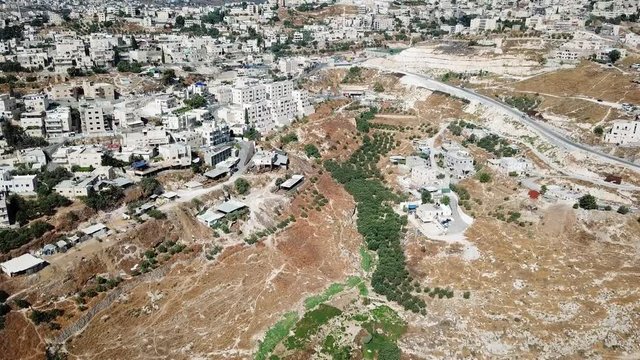 Aerial footage over  East Jerusalem Palestinian neighborhood jabel mukaber Drone View over Judea Desert and arab neighborhoods in East jerusalem