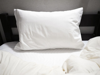 Fototapeta na wymiar white pillow on wooden bed