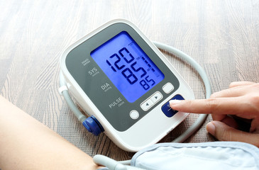 woman check blood pressure monitor and heart rate monitor pressure gauge. Health care and Medical concept