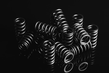motorcycle valve springs on a black reflective background
