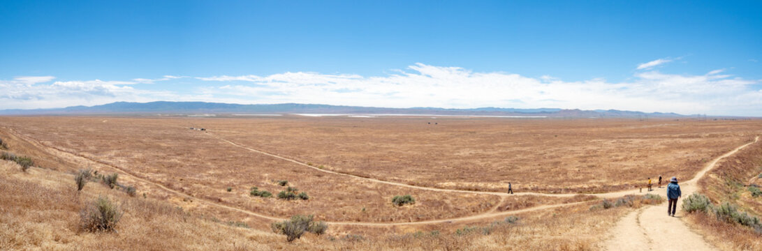 Family walking at Wallace Creek Trail, San Andreas Fault, Carizzo Plain National Monument on sunny spring day, Kern County, California, Central Valley