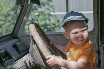 Child driving an old car